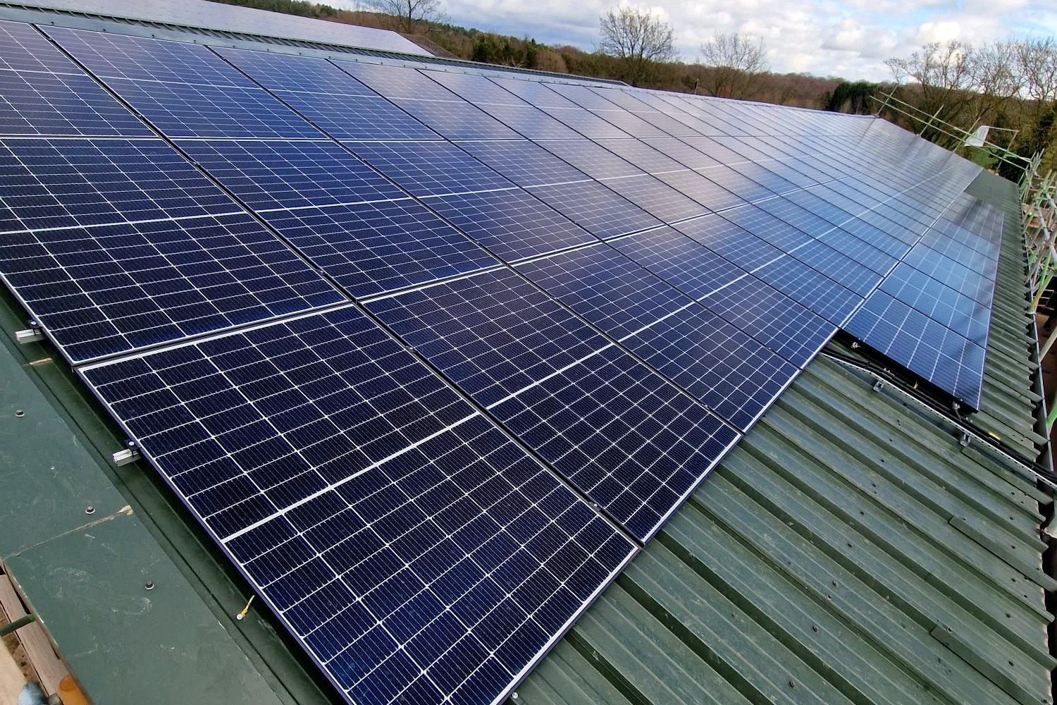 Roof-mounted commercial solar PV array installed on an agricultural building at a farm near Solihull